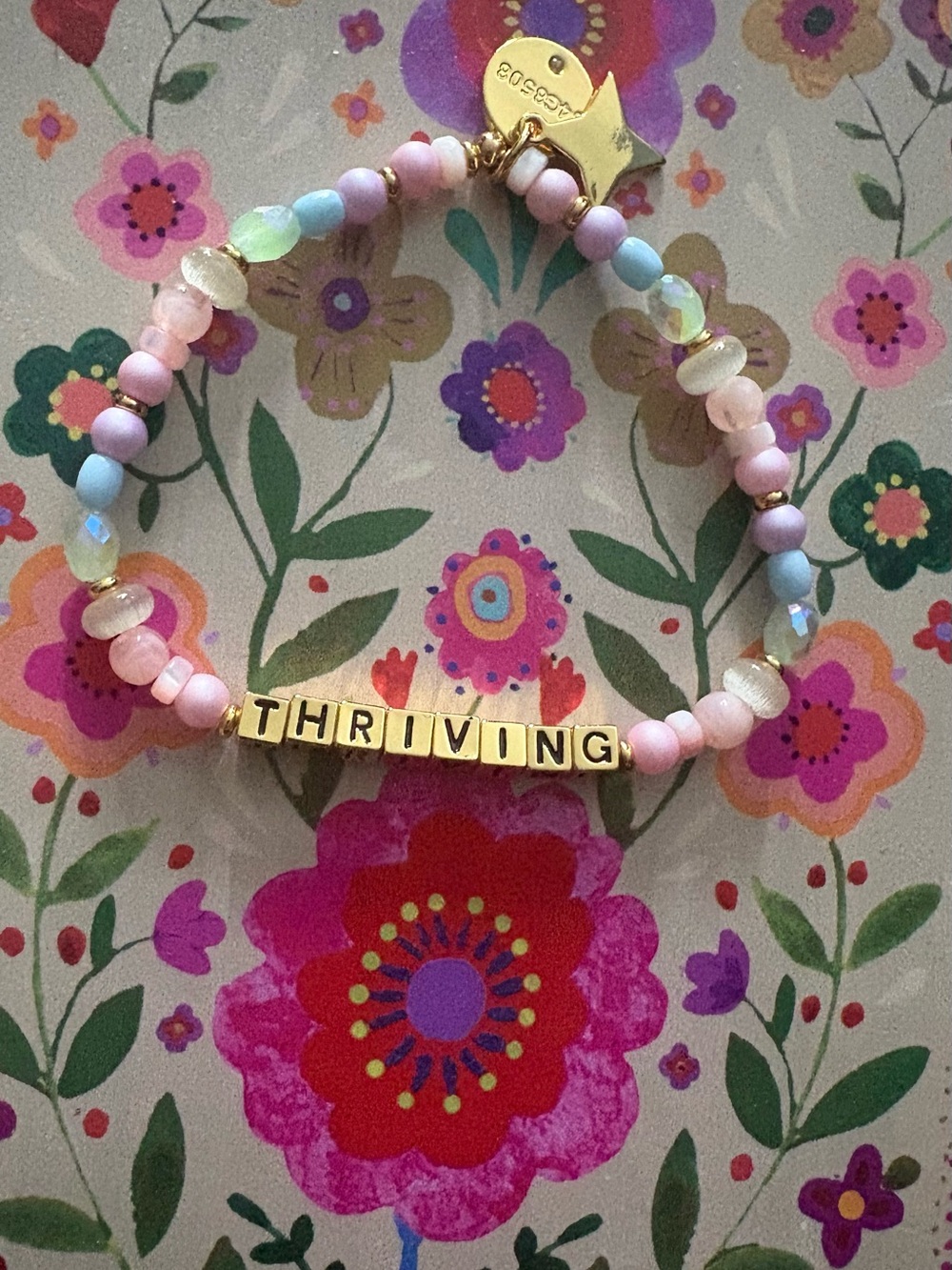 Gold 'THRIVING' Little Words project word of the month for May.